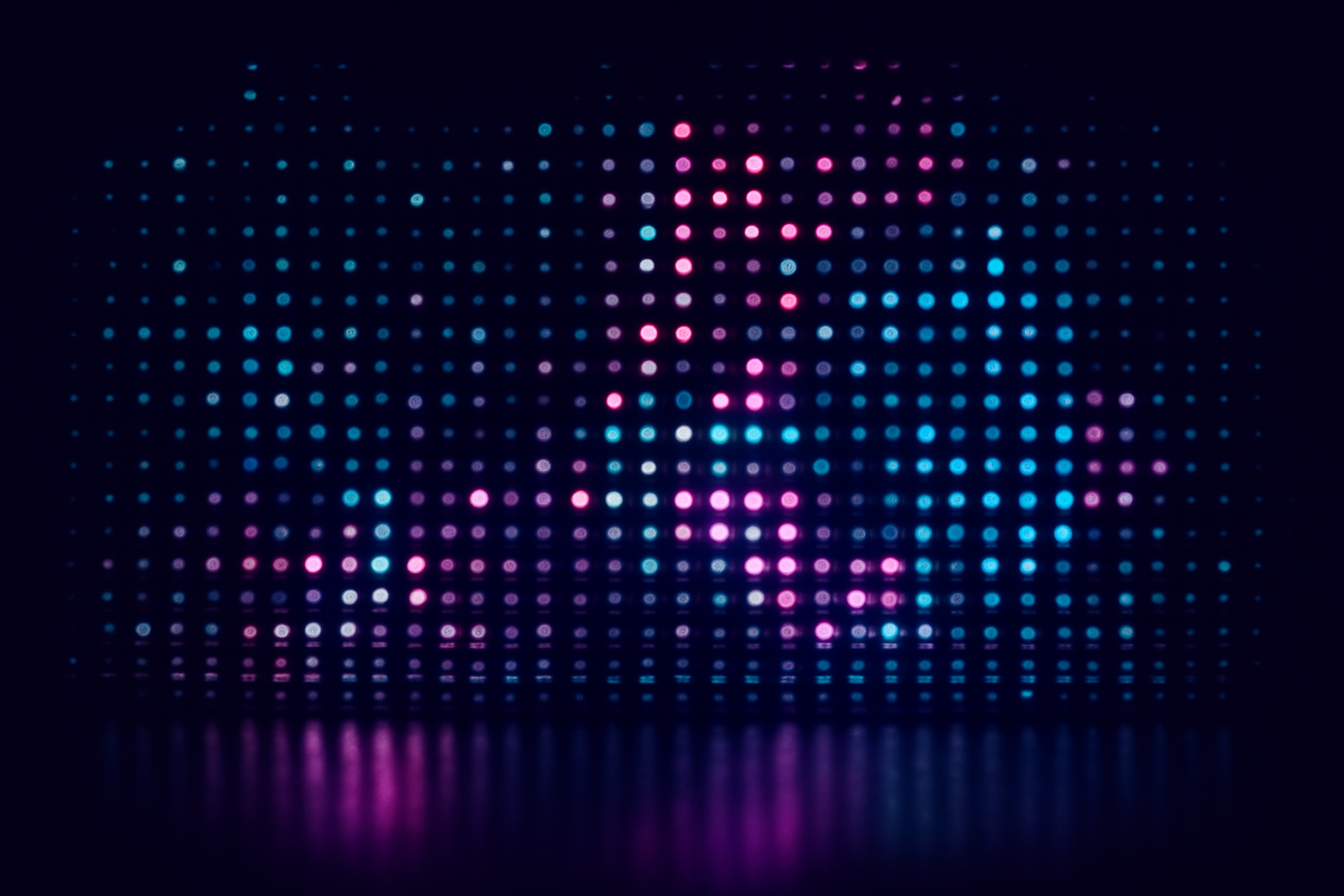 An abstract data graphic featuring a grid of small, glowing multi-colored dots, with some areas more densely populated than others, against a dark background.